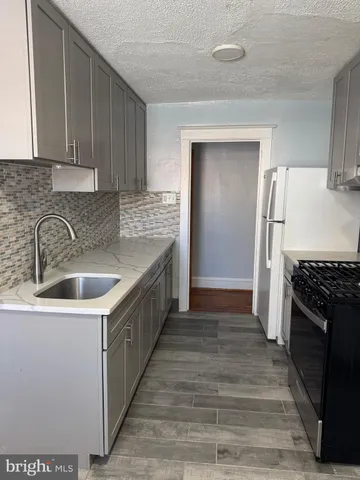 a kitchen that has a sink and a stove