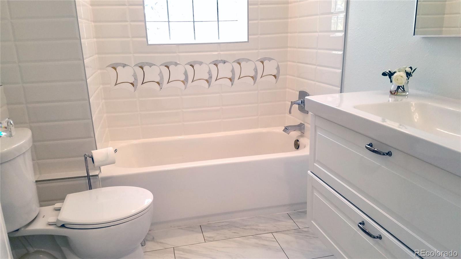 4630 Quay Street Wheat Ridge, CO 80033 - Photo 26 of 36 a bathroom with a sink a toilet and bathtub