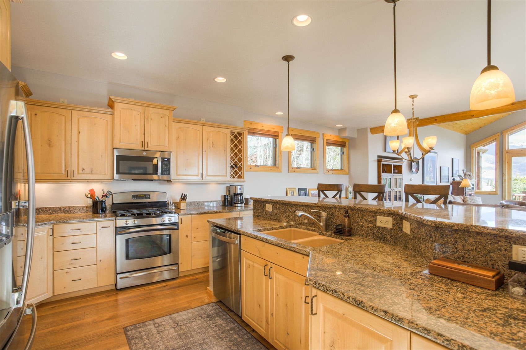 727 Willowbrook Road Silverthorne, CO 80498 - Photo 7 of 47 a kitchen with stainless steel appliances granite countertop a sink a stove and a wooden floors