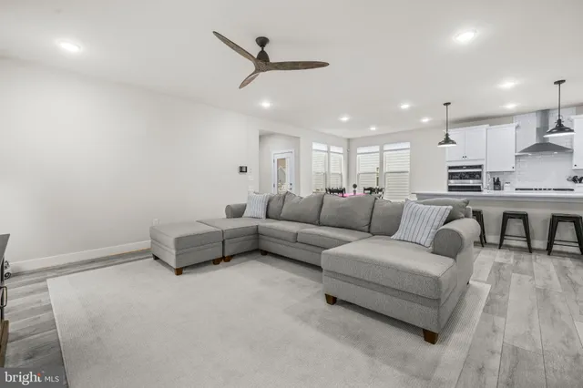 a room with a table chairs and a window