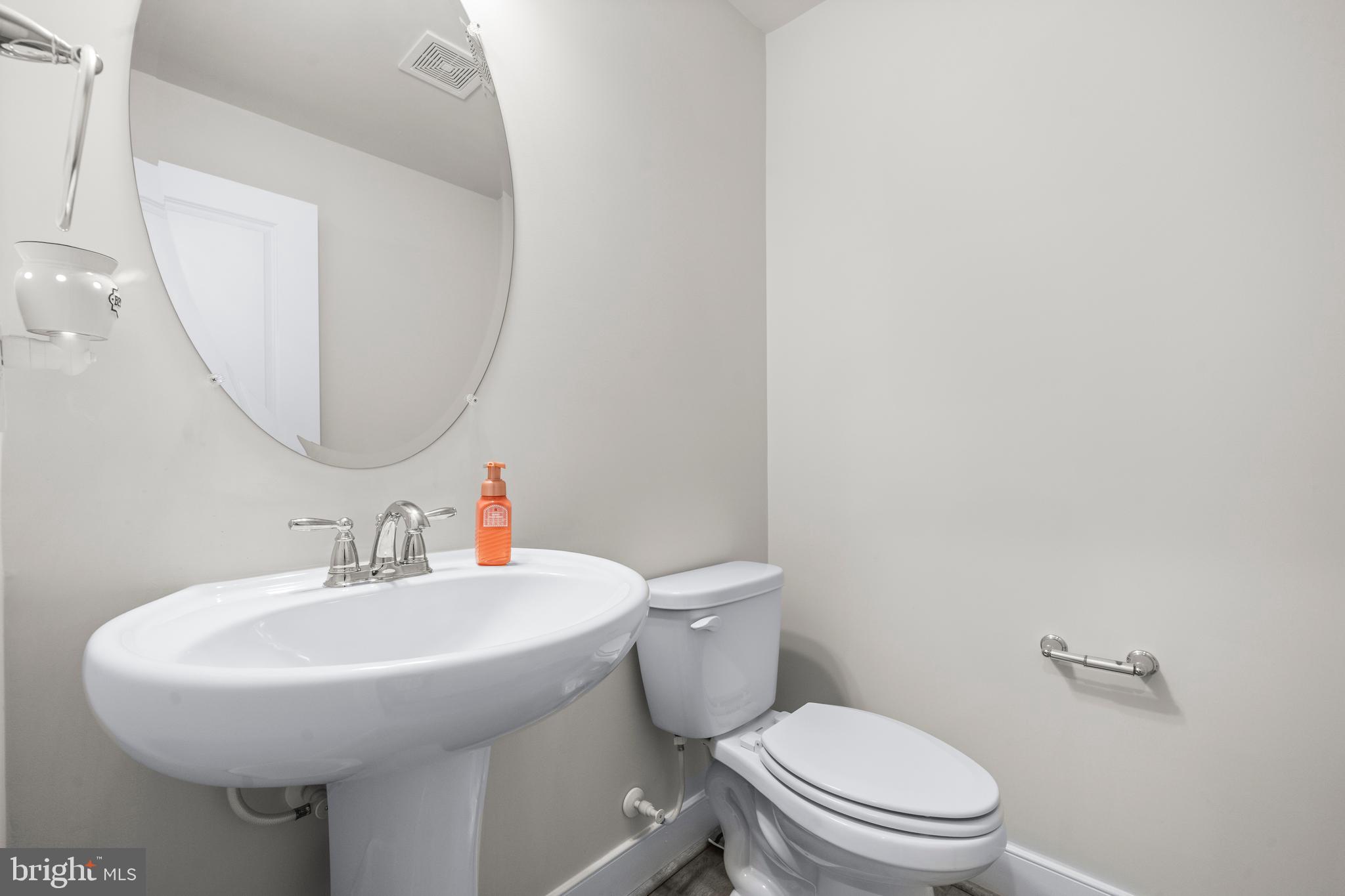 1814 River Heritage Boulevard Dumfries, VA 22026 - Photo 16 of 55 a bathroom with a toilet a sink and mirror