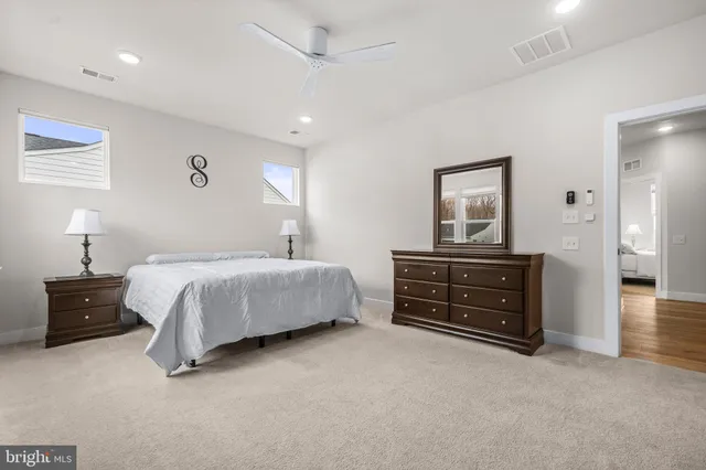 a spacious bedroom with a large bed and a flat screen tv