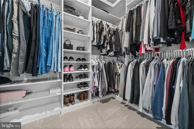 a bedroom with a bed a lamp and window