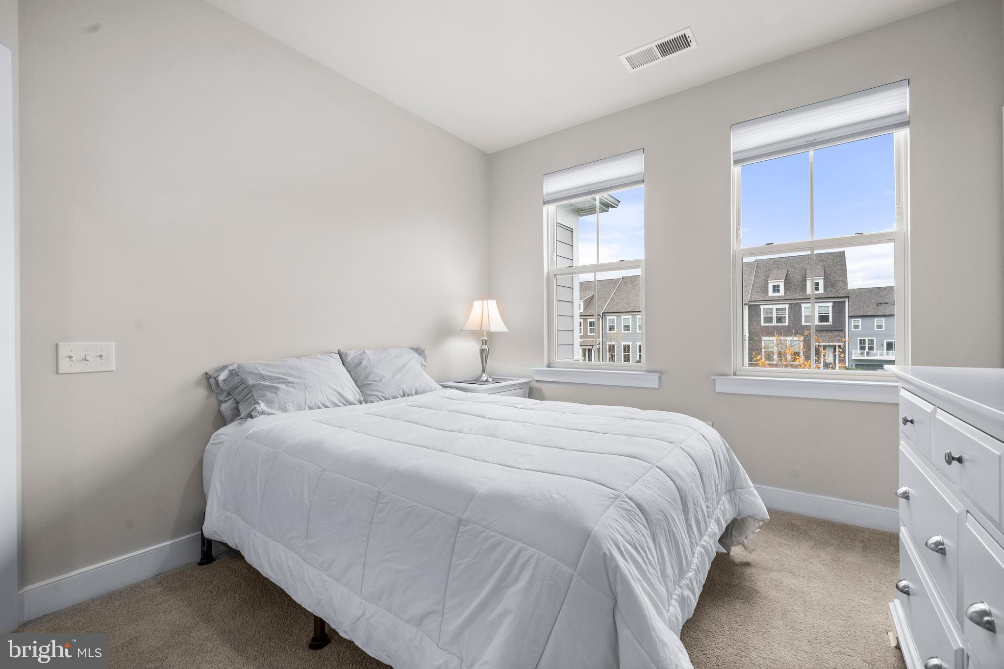 1814 River Heritage Boulevard Dumfries, VA 22026 - Photo 23 of 55 a bedroom with a bed a lamp and window