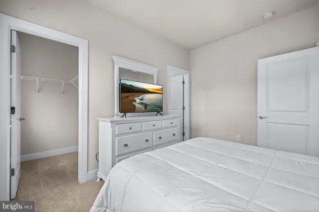 a bathroom with a sink a toilet a light fixture and a mirror