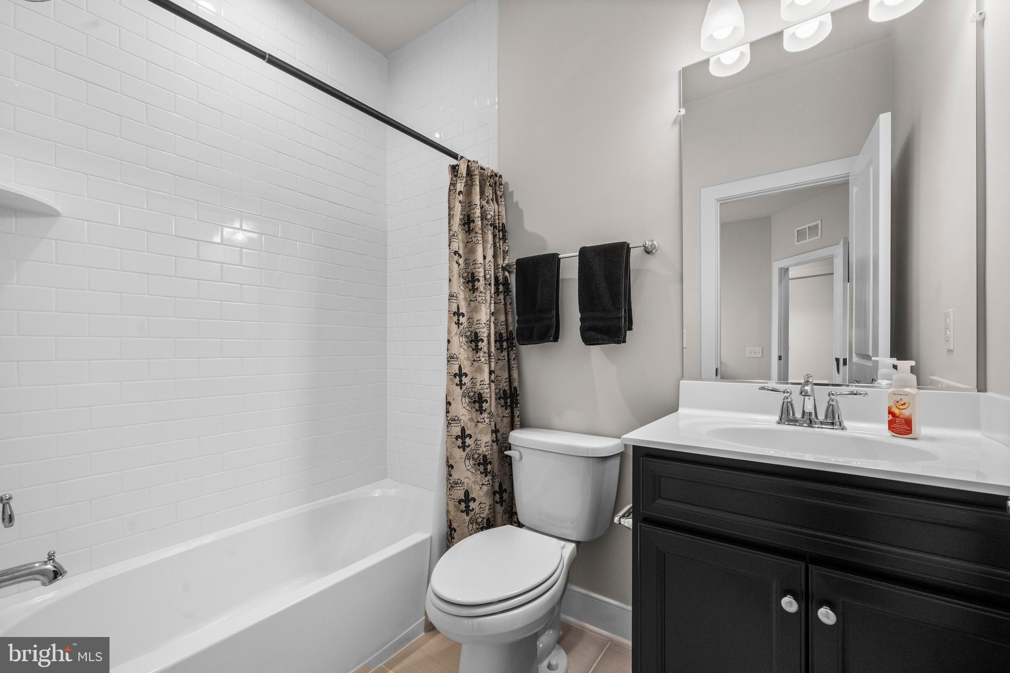 1814 River Heritage Boulevard Dumfries, VA 22026 - Photo 25 of 55 a bathroom with a sink a toilet and shower