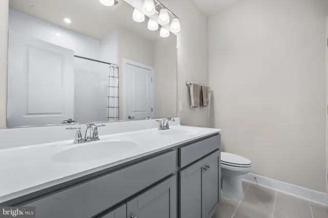 a view of hallway with a couch and a flat screen tv