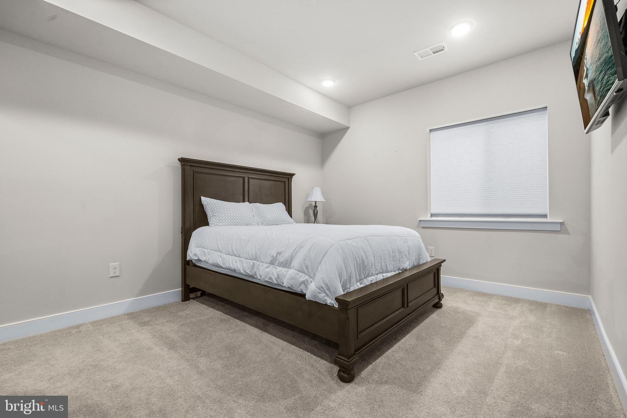 1814 River Heritage Boulevard Dumfries, VA 22026 - Photo 34 of 55 a bed sitting in a spacious bedroom next to a window