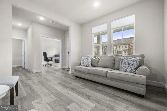 a living room with furniture and a large window