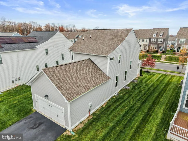 an aerial view of a tennis ground and a cars park side of the road
