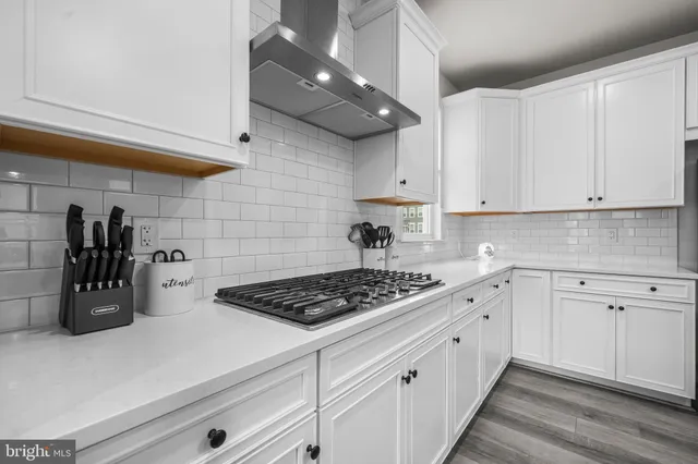 a view of a room with furniture and wooden floor