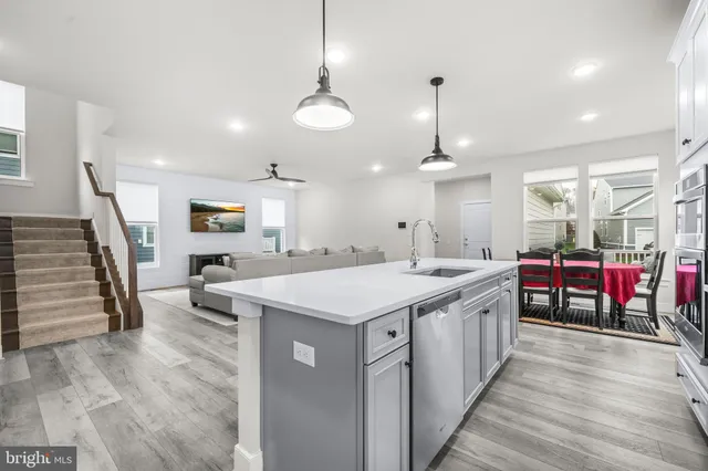 a view of walk in closet with wooden floor