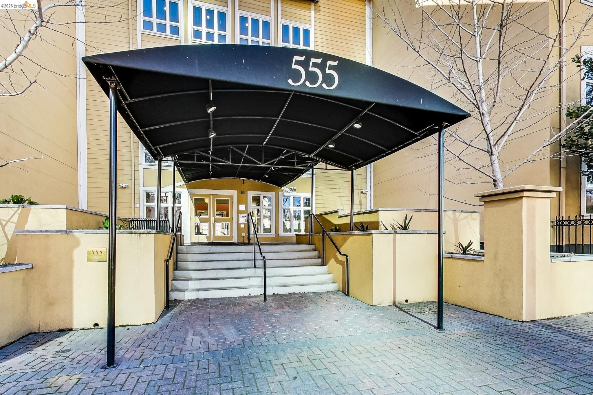 555 10th Street, Unit 312 Oakland, CA 94607 - Photo 2 of 34 a view of a porch with wooden floor and stairs