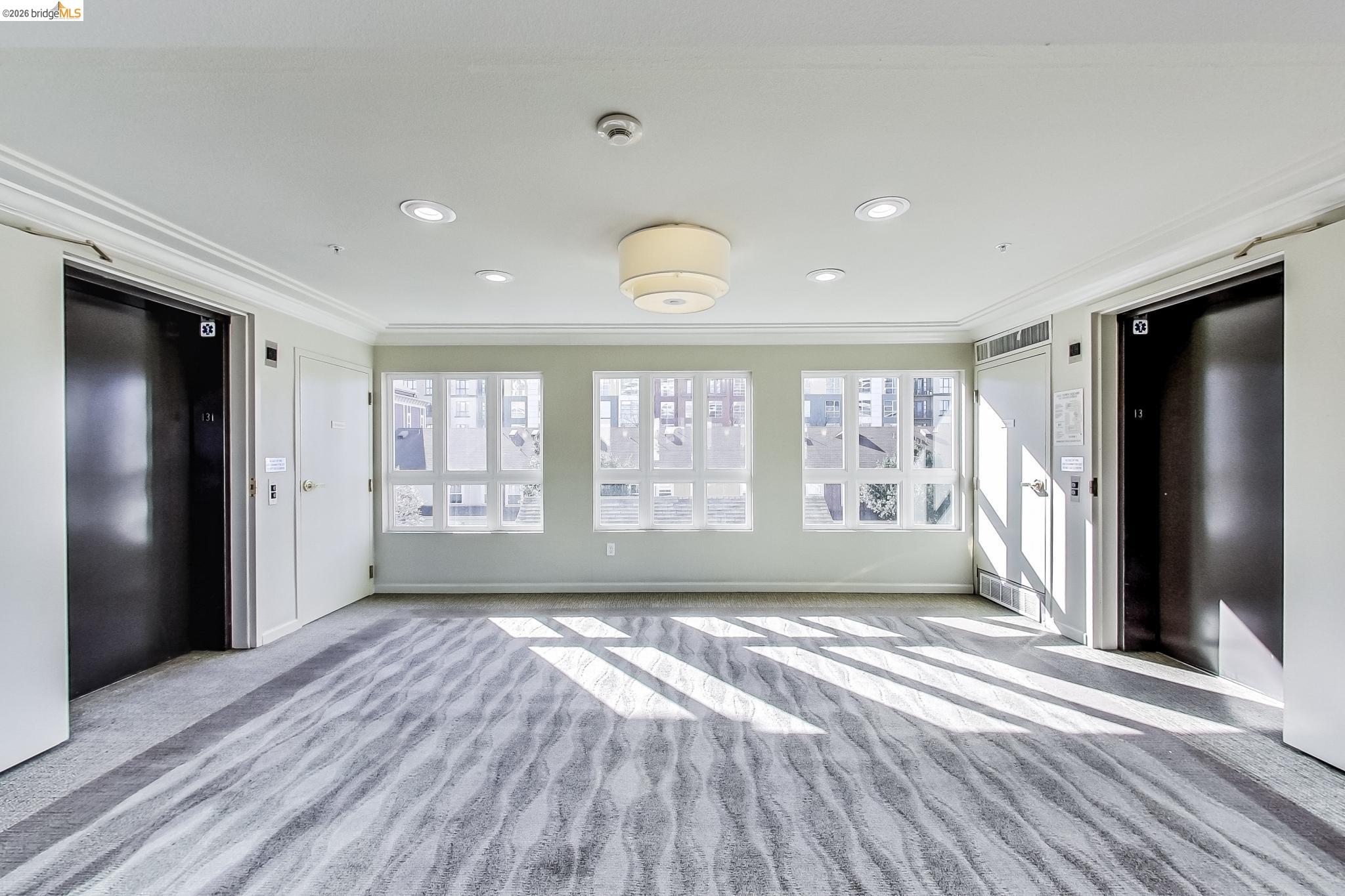 555 10th Street, Unit 312 Oakland, CA 94607 - Photo 22 of 34 a view of empty room with wooden floor and fan