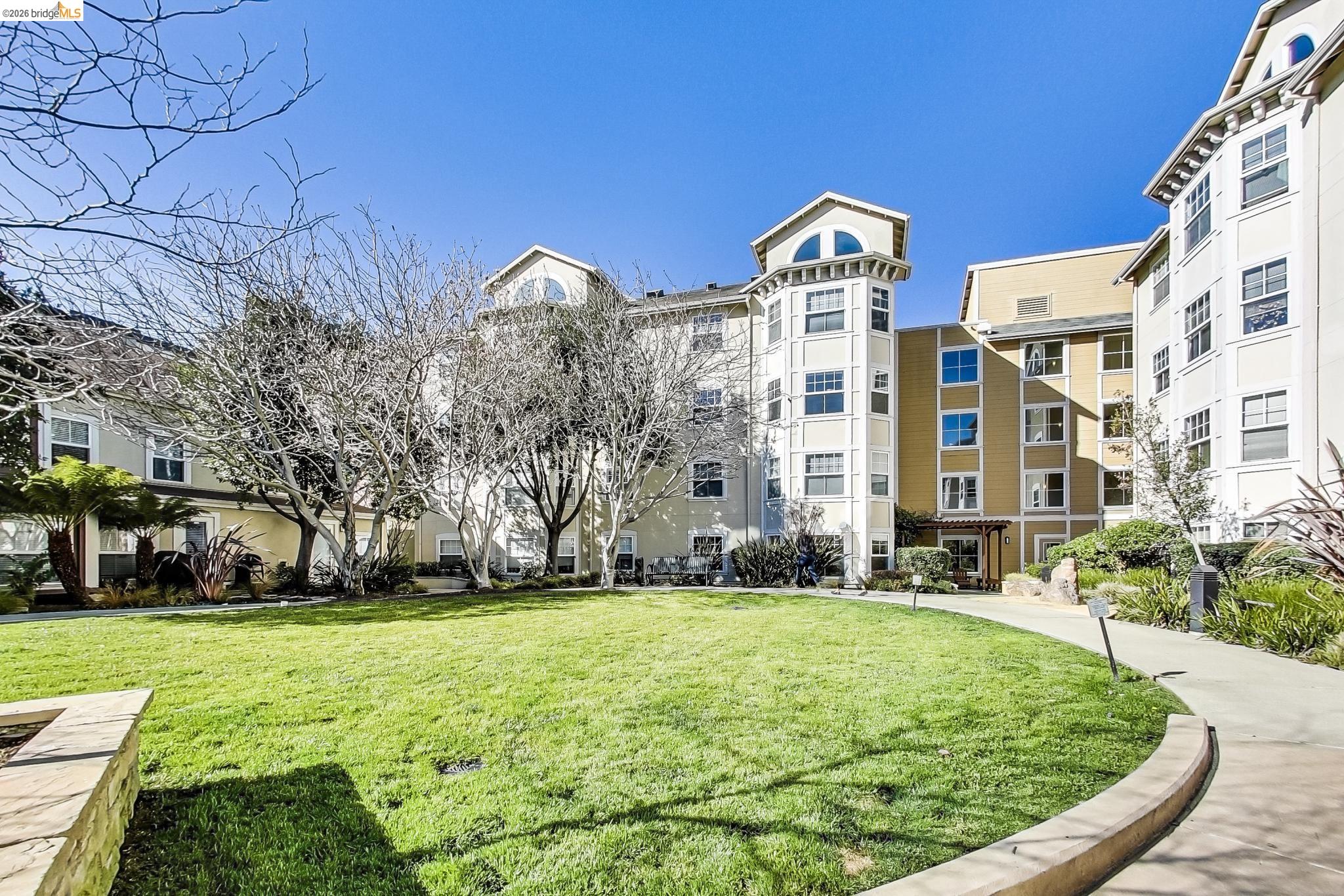 555 10th Street, Unit 312 Oakland, CA 94607 - Photo 32 of 34 a view of a big building with big yard and large trees