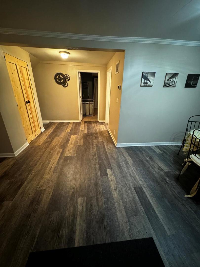 11 Cross Street Bristol, IL 60512 - Photo 6 of 11 a view of empty room with wooden floor and fan