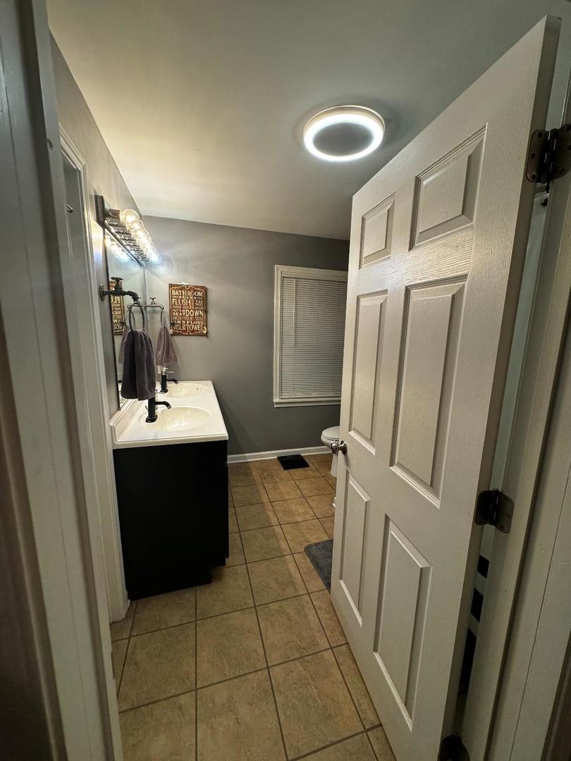 11 Cross Street Bristol, IL 60512 - Photo 10 of 11 a bathroom with a sink and mirror
