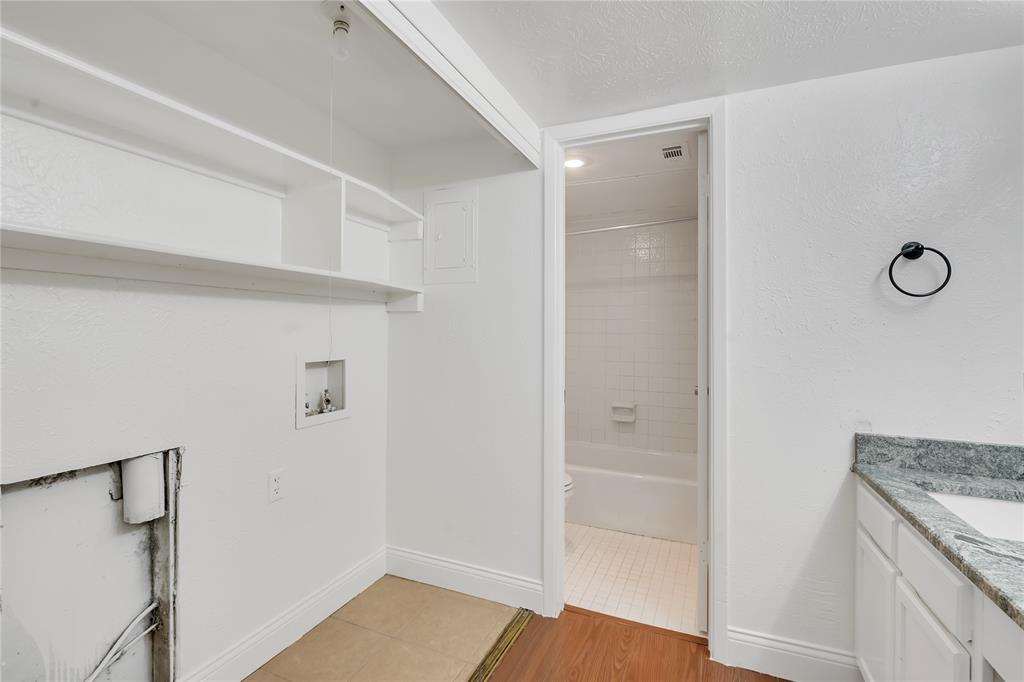4525 North O'Connor Road, Unit 1184 Irving, TX 75062 - Photo 11 of 20 Utility area featuring built-in shelving and connections for laundry appliances