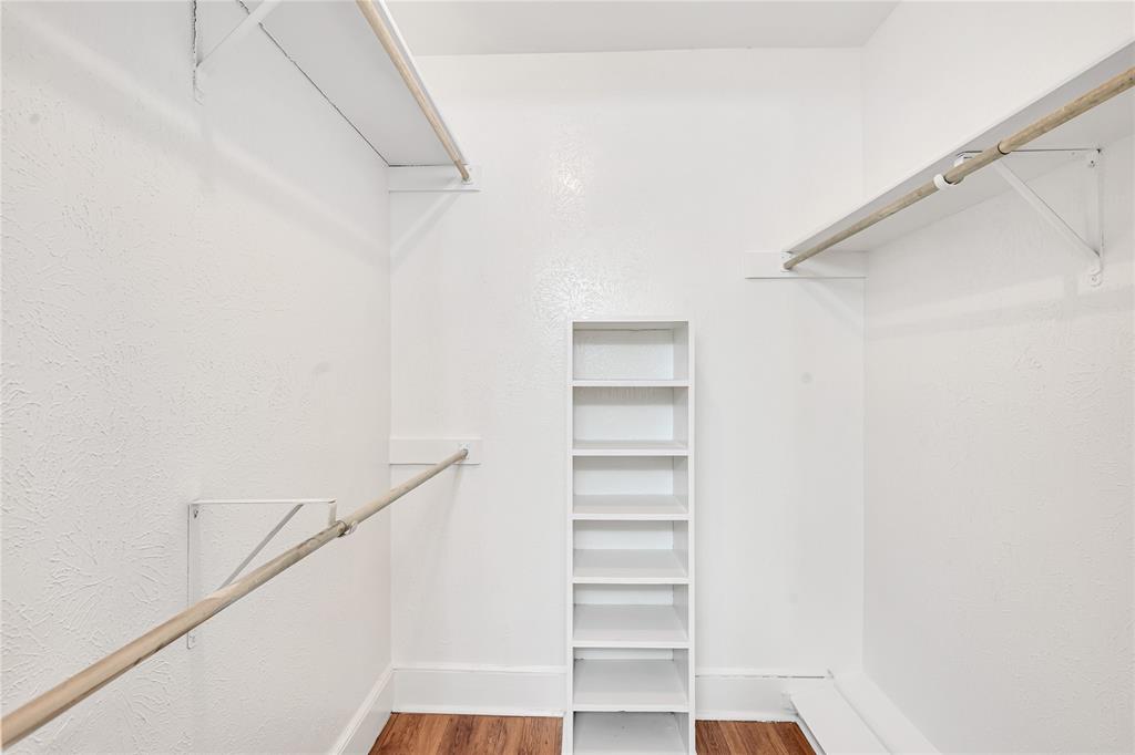 4525 North O'Connor Road, Unit 1184 Irving, TX 75062 - Photo 17 of 20 Walk-in closet featuring white walls, shelving units, and hanging rods