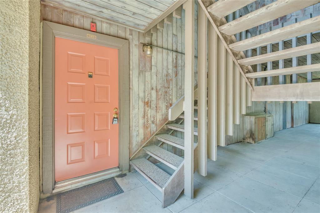 4525 North O'Connor Road, Unit 1184 Irving, TX 75062 - Photo 2 of 20 Entrance featuring a panel door, an outdoor wall sconce, and a staircase with carpeted treads