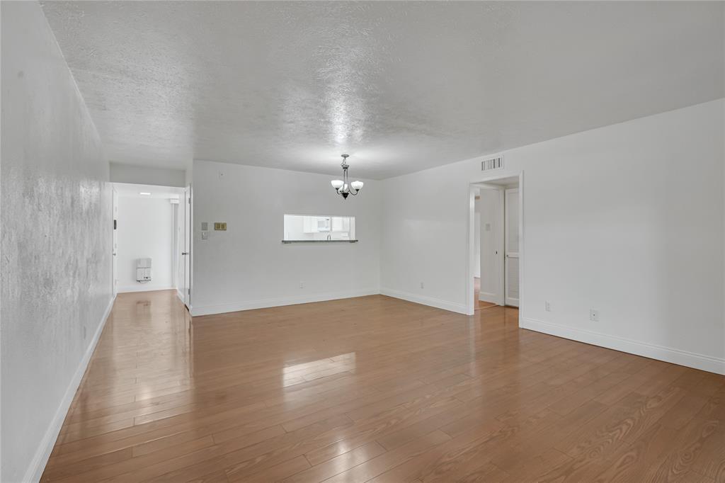 4525 North O'Connor Road, Unit 1184 Irving, TX 75062 - Photo 6 of 20 Spacious open concept living area with hardwood floors and light-colored walls