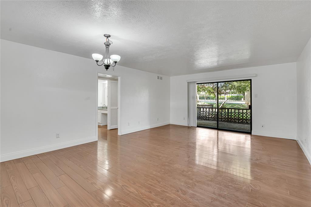 4525 North O'Connor Road, Unit 1184 Irving, TX 75062 - Photo 7 of 20 This inviting space features light wood flooring, white walls, and a contemporary chandelier