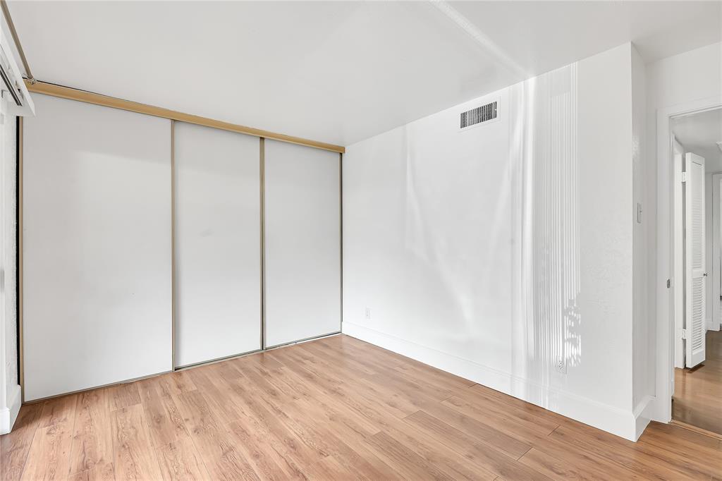 4525 North O'Connor Road, Unit 1184 Irving, TX 75062 - Photo 9 of 20 The property features hardwood flooring and bright white walls