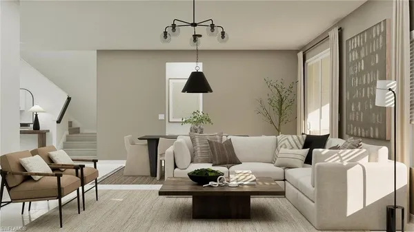 a living room with furniture and a chandelier