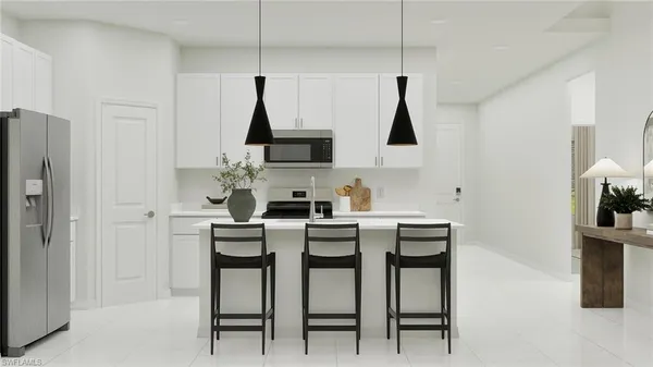 a kitchen with stainless steel appliances a table chairs and a refrigerator