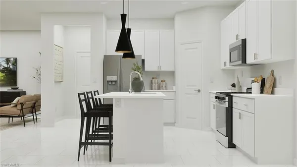 a kitchen with stainless steel appliances a sink a stove a refrigerator and cabinets