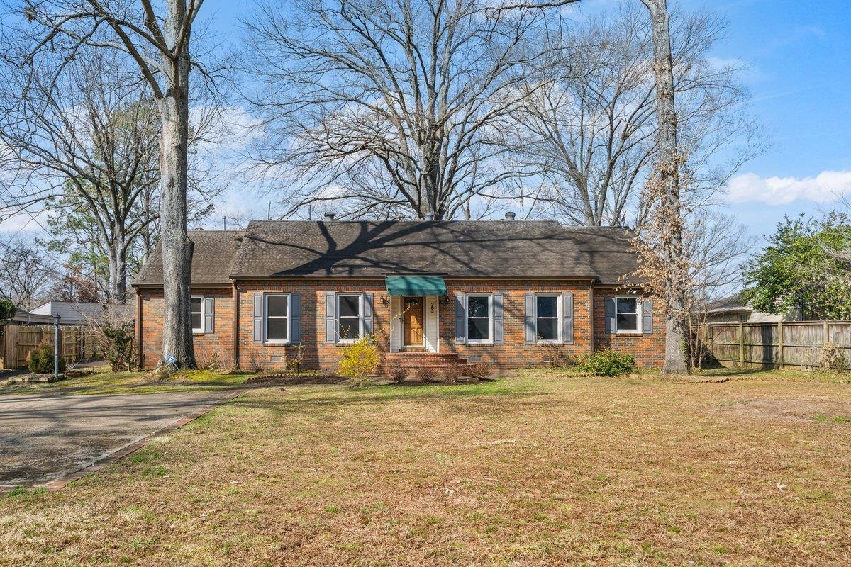 Ranch-style house featuring brick siding and roof with shingles