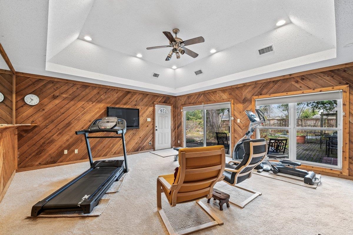 353 Colonial Road Memphis, TN 38117 - Photo 14 of 37 Exercise room featuring carpet flooring, wood walls, a ceiling fan, and recessed lighting