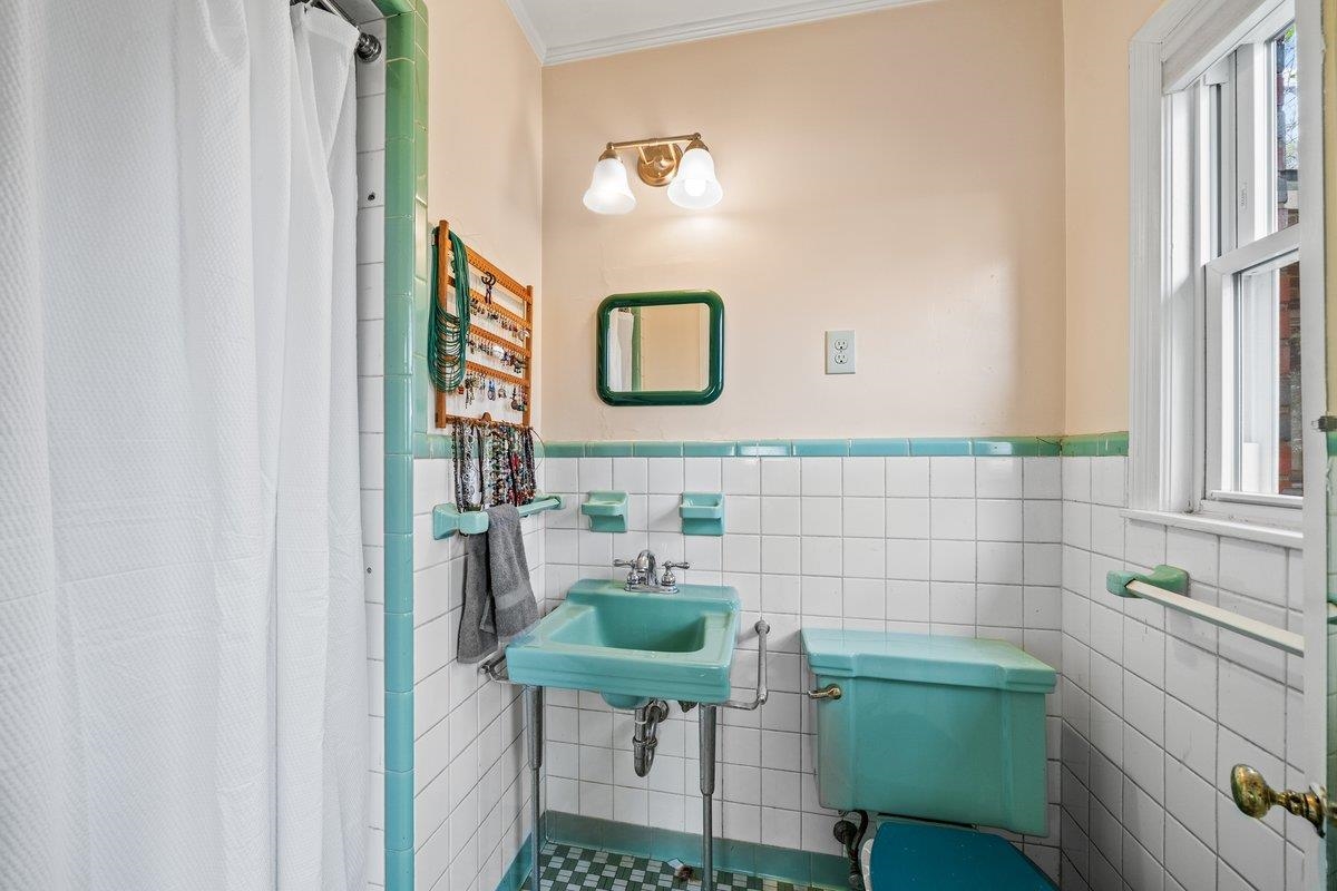 353 Colonial Road Memphis, TN 38117 - Photo 19 of 37 Full bath featuring a stall shower, wainscoting, tile walls, and crown molding