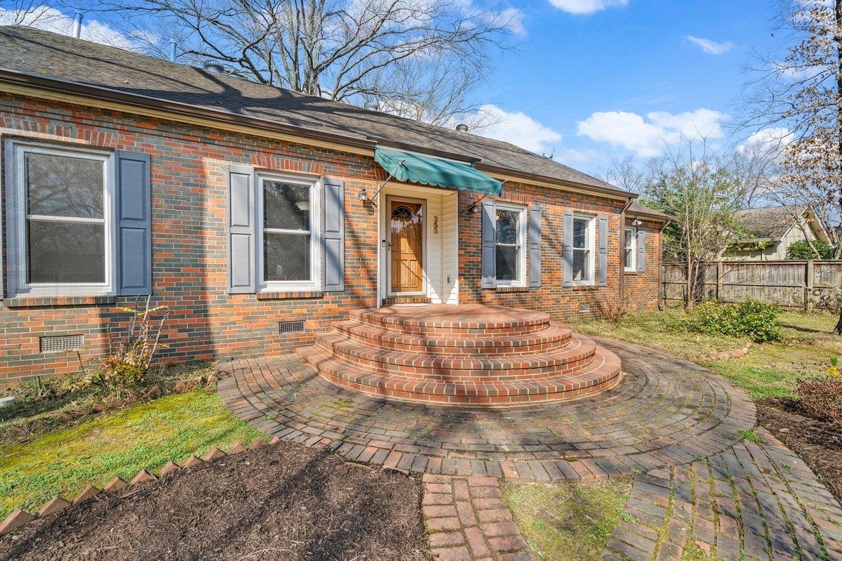 353 Colonial Road Memphis, TN 38117 - Photo 2 of 37 View of front of home with brick siding and roof with shingles