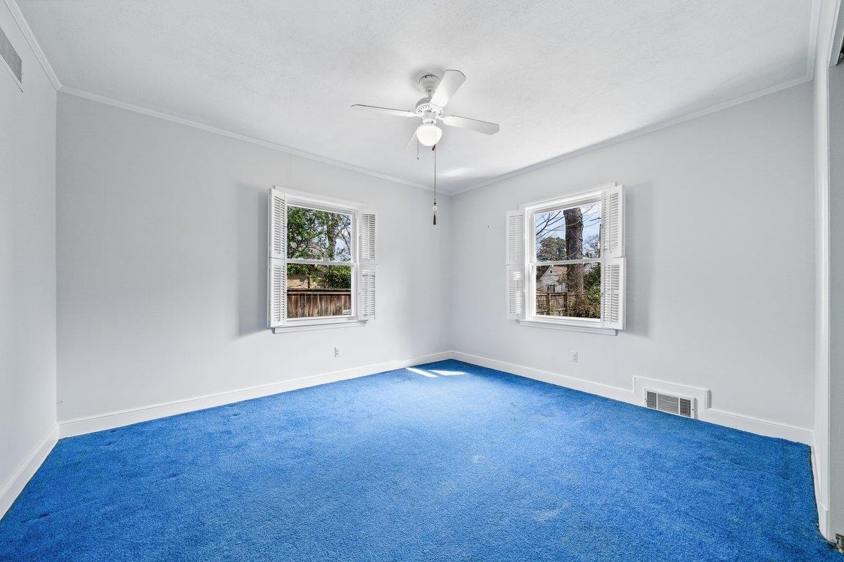 353 Colonial Road Memphis, TN 38117 - Photo 21 of 37 Unfurnished room with ornamental molding, carpet, and a ceiling fan