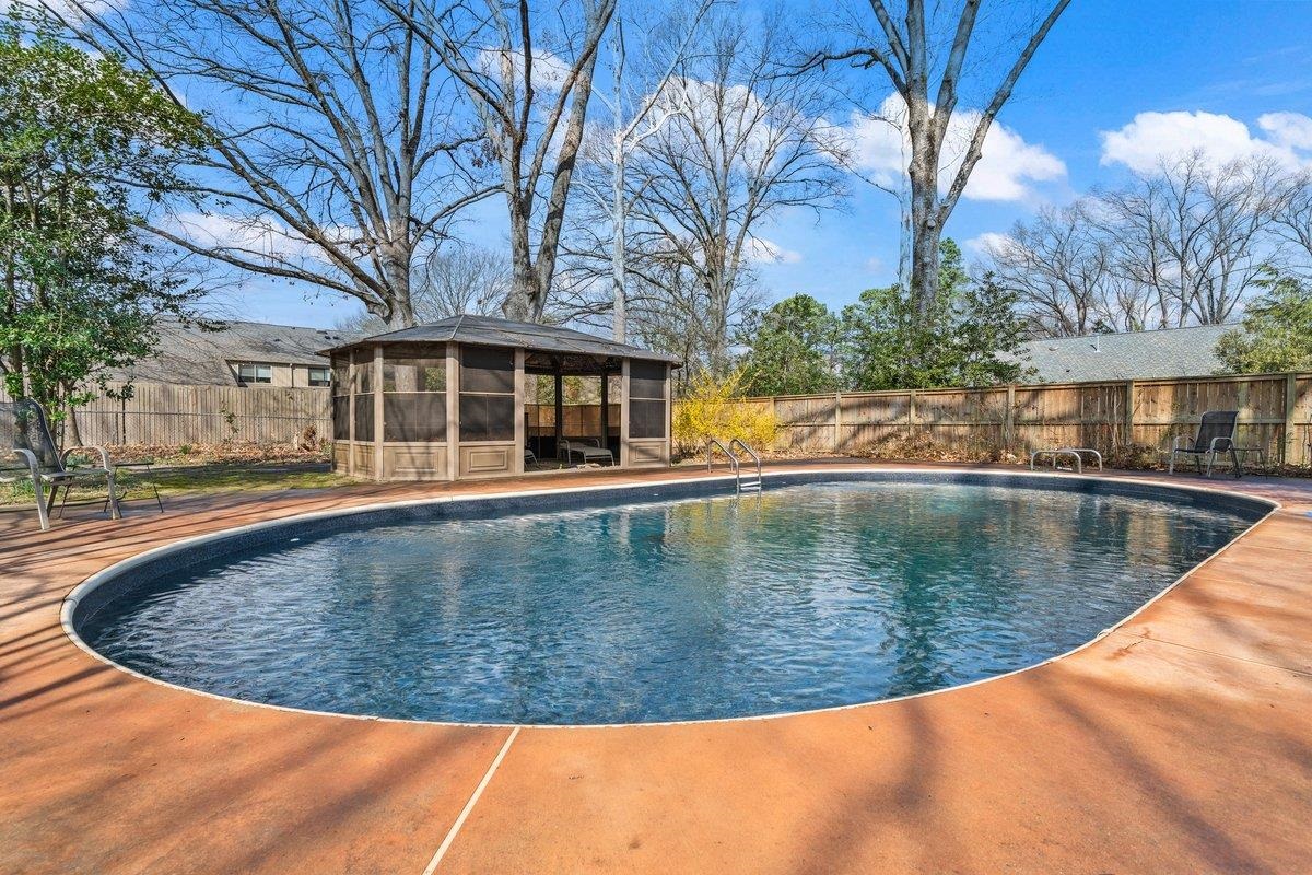 353 Colonial Road Memphis, TN 38117 - Photo 30 of 37 View of swimming pool with a fenced backyard and a sunroom