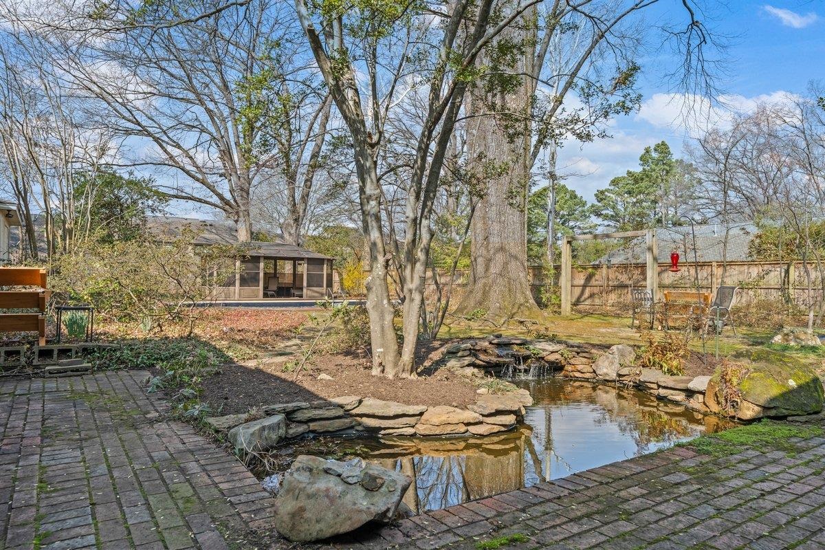 353 Colonial Road Memphis, TN 38117 - Photo 33 of 37 View of yard featuring a small pond, a gazebo, a patio, and a pool