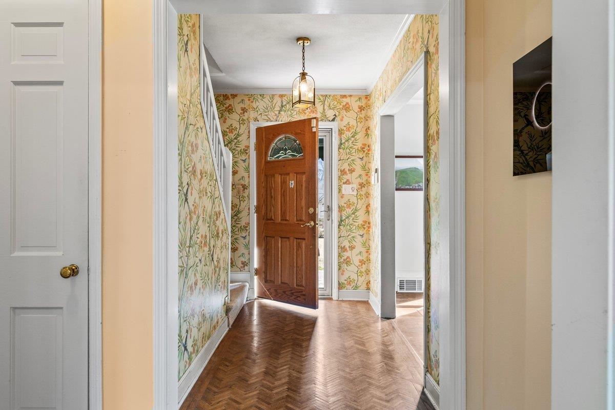 353 Colonial Road Memphis, TN 38117 - Photo 5 of 37 Foyer with parquet flooring and wallpapered walls