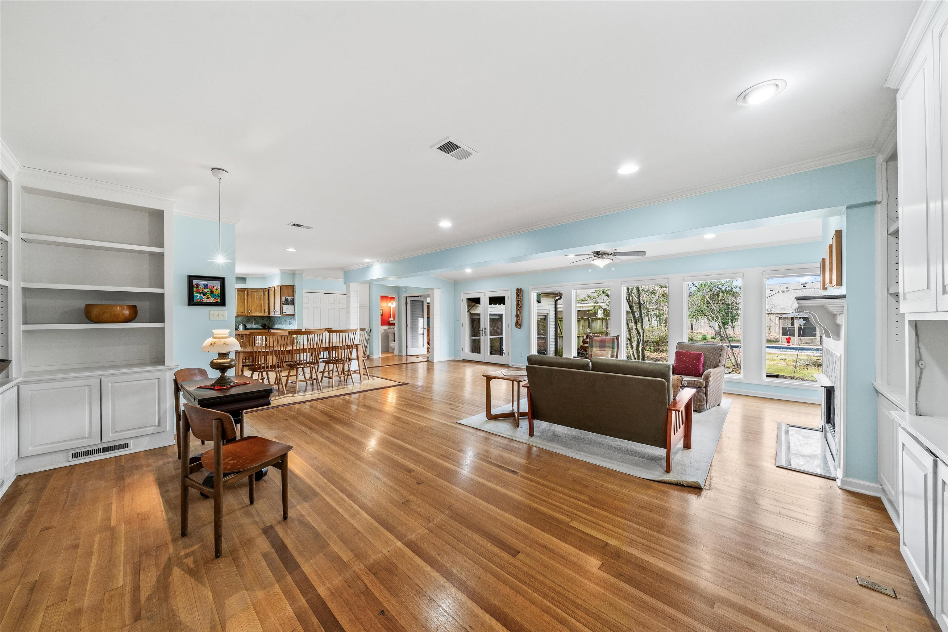 353 Colonial Road Memphis, TN 38117 - Photo 9 of 37 Living room with light wood finished floors, a ceiling fan, ornamental molding, recessed lighting, and built in shelves