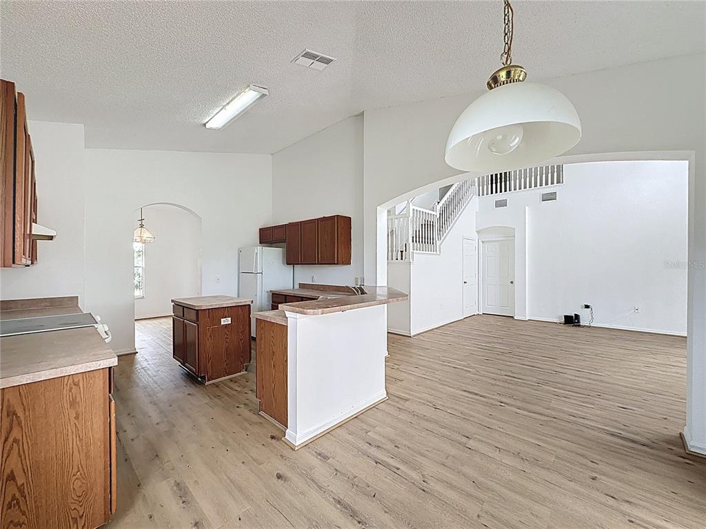 1430 Nelson Brook Way Kissimmee, FL 34759 - Photo 12 of 37 a kitchen with stainless steel appliances granite countertop a stove refrigerator and a sink with wooden floor
