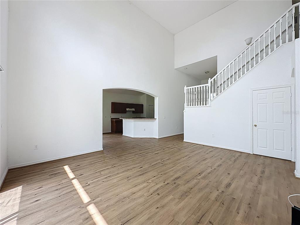 1430 Nelson Brook Way Kissimmee, FL 34759 - Photo 17 of 37 a view of empty room with wooden floor and fan