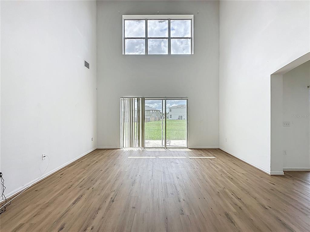 1430 Nelson Brook Way Kissimmee, FL 34759 - Photo 19 of 37 an empty room with wooden floor and windows