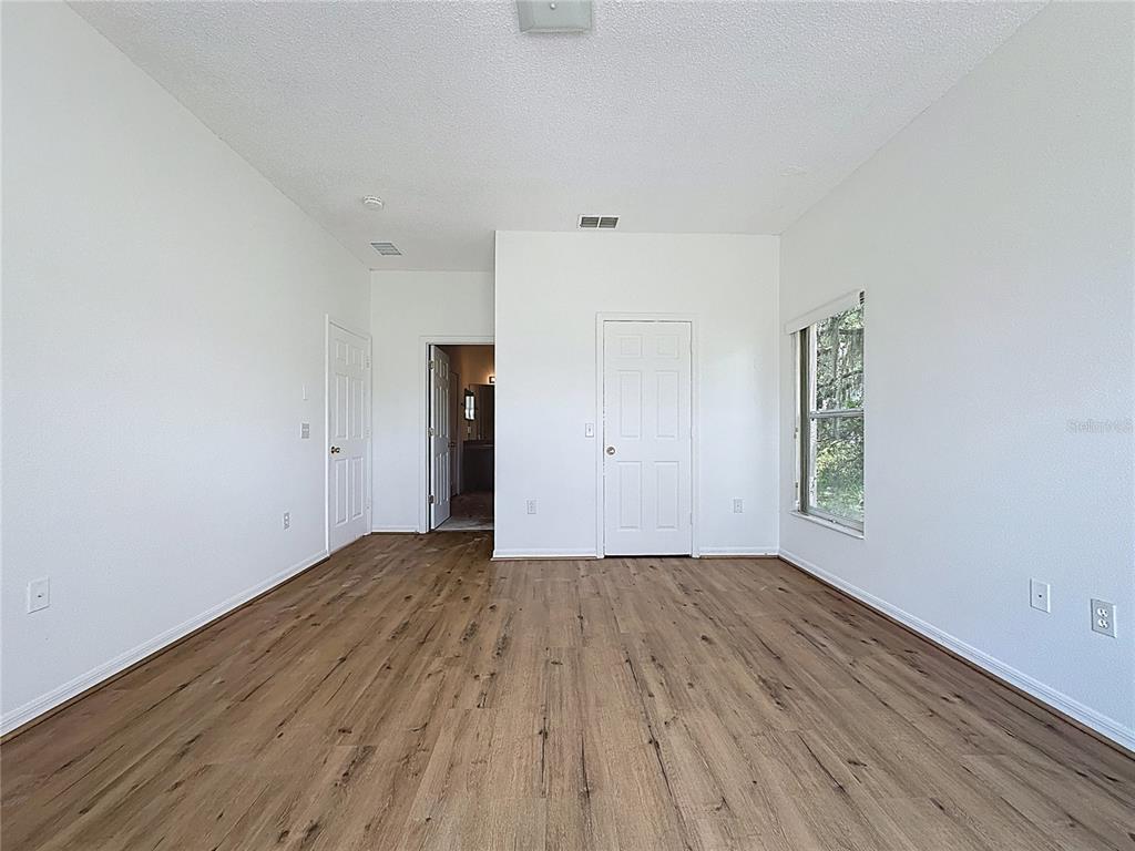 1430 Nelson Brook Way Kissimmee, FL 34759 - Photo 20 of 37 an empty room with wooden floor and windows
