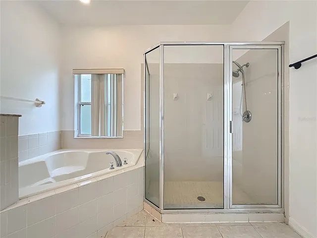 a bathroom with a bathtub and shower