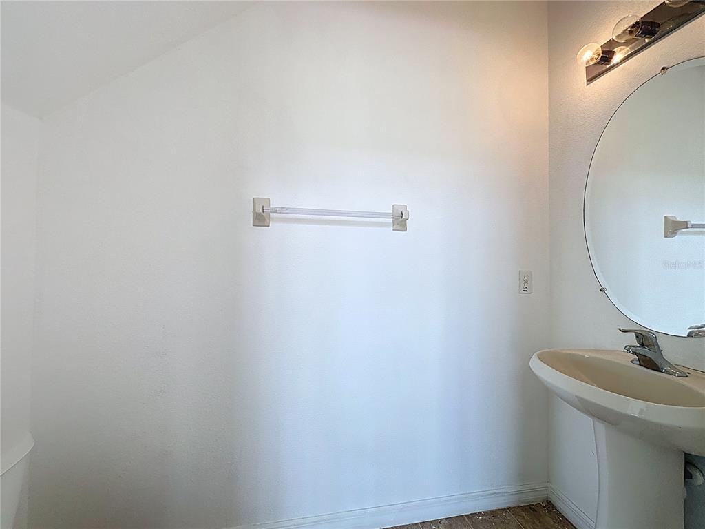 1430 Nelson Brook Way Kissimmee, FL 34759 - Photo 24 of 37 a bathroom with a sink and mirror