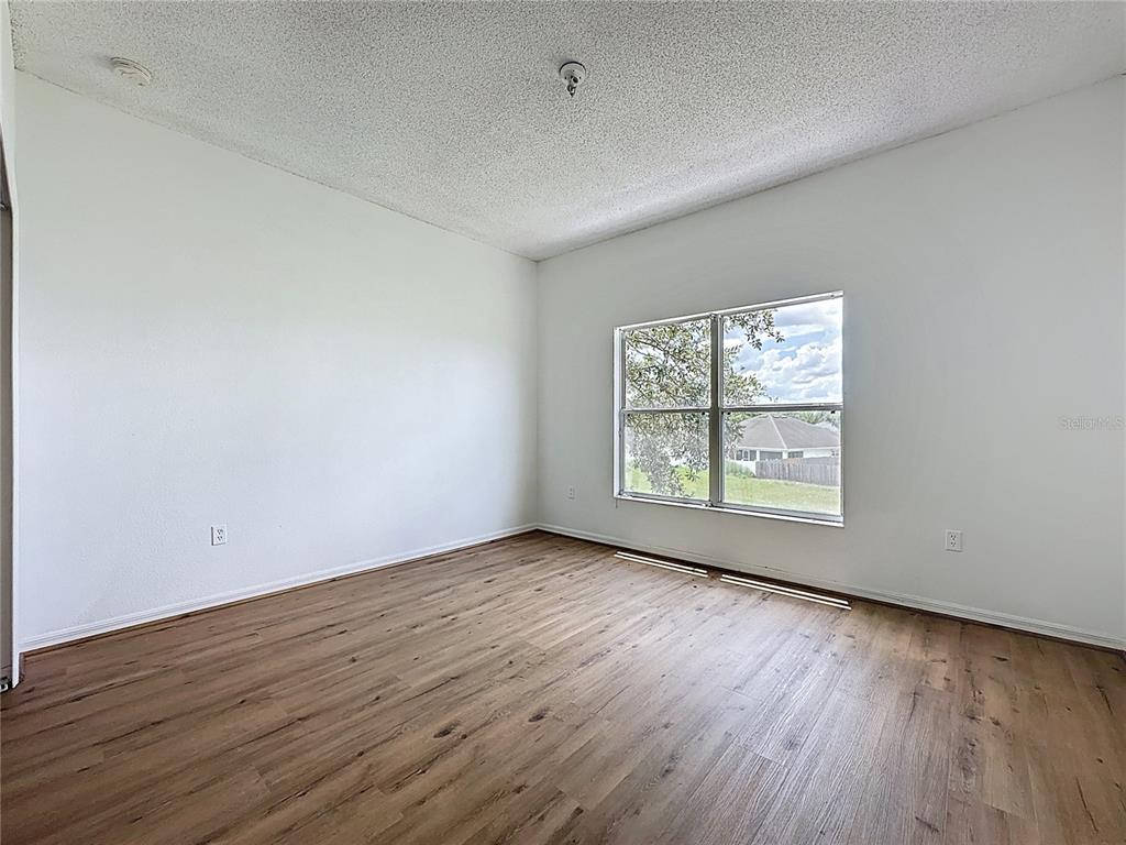 1430 Nelson Brook Way Kissimmee, FL 34759 - Photo 31 of 37 an empty room with wooden floor and windows