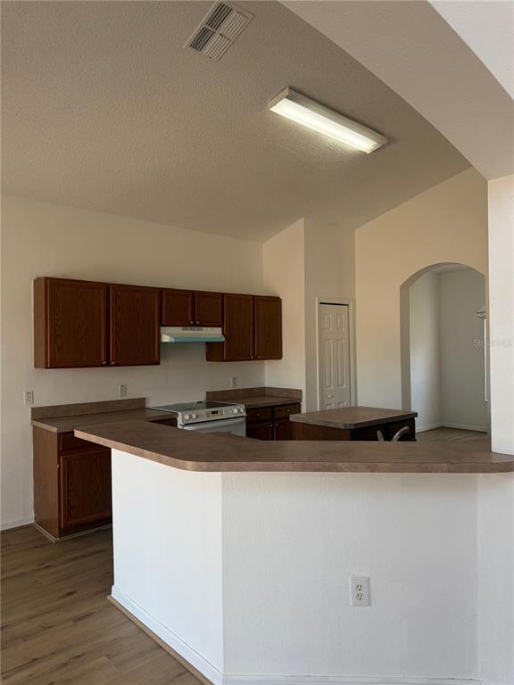 1430 Nelson Brook Way Kissimmee, FL 34759 - Photo 7 of 37 a kitchen with a sink and a stove top oven