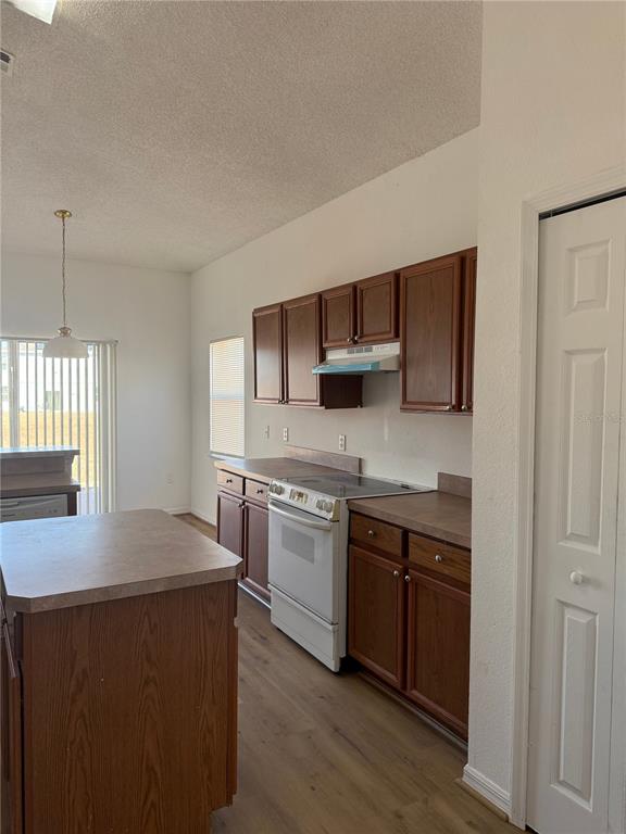 1430 Nelson Brook Way Kissimmee, FL 34759 - Photo 9 of 37 a kitchen with stainless steel appliances granite countertop a sink and stove top oven