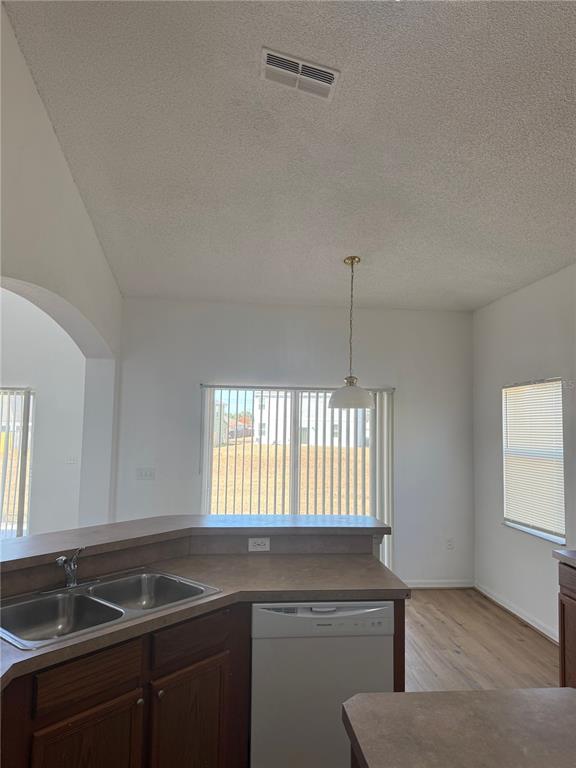 1430 Nelson Brook Way Kissimmee, FL 34759 - Photo 10 of 37 a kitchen that has a sink cabinets and a window