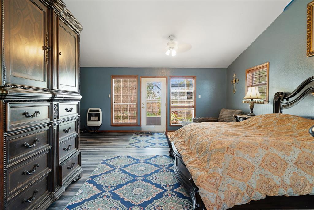 3178 East 2150 Road Grant, OK 74738 - Photo 13 of 40 a spacious bedroom with a bed and dresser with mirror